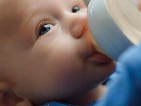 Bebe tomando su leche del biberón