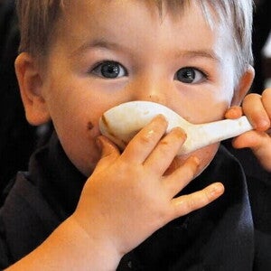 Niño tomando sopa con una cuchara